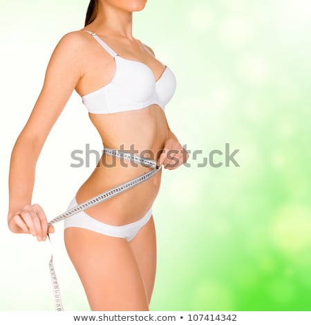 Foto stock: Girl Taking Measurements Of Her Body Green Blurred Background