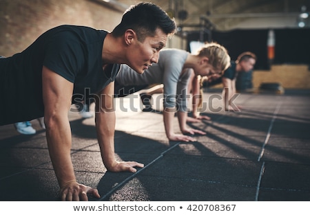 Stock fotó: Gym Man And Woman Push Up Strength Pushup