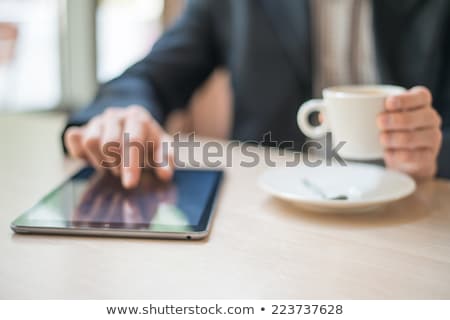 Zdjęcia stock: Man With Tablet Computer Reading News At Motning