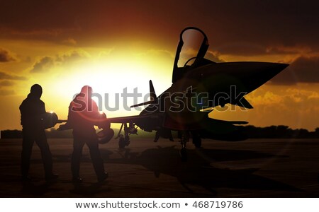 Stock foto: Military Aircraft On Airfield With Pilot Walking Towards The Aircraft