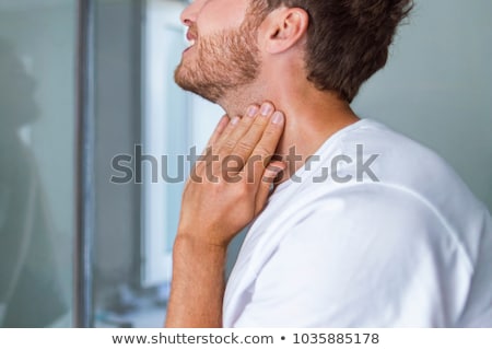 Stockfoto: Doctor Checking Skin On Mans Neck