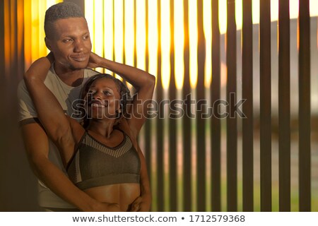 Сток-фото: Sporty Young Woman Resting By Metal Fence