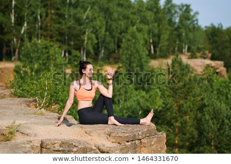 Foto stock: Turning Body While Strengthening Spinal Core