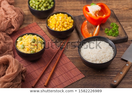 Stock fotó: Black Bowl With Boiled Organic Basmati Vegetable Rice With Wooden Chopsticks On Brown Placemat With