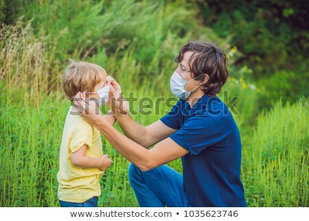 Stock fotó: Father And Son In A Medical Mask Because Of An Allergy To Ragweed
