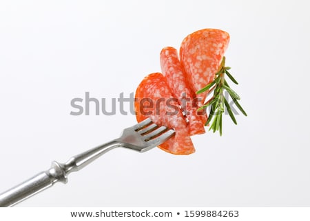 Stock foto: Thin Salami Slice And Rosemary On Fork