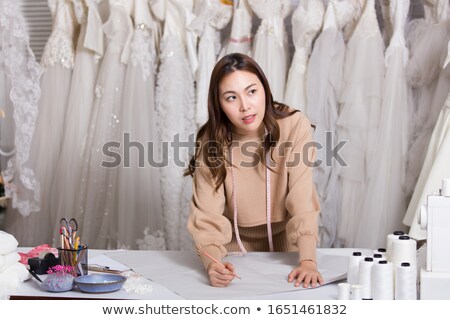 Zdjęcia stock: Dressmaker Showing Design To Bride