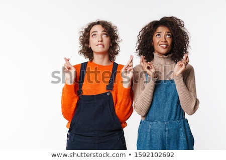 Zdjęcia stock: Portrait Of Multinational Women Looking Upward With Fingers Crossed