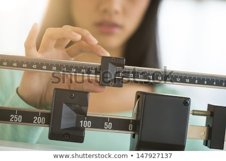 Сток-фото: Woman Adjusting Scale