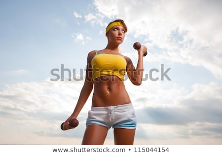 Stockfoto: Athletic Girl Does Exercise With Dumbbells