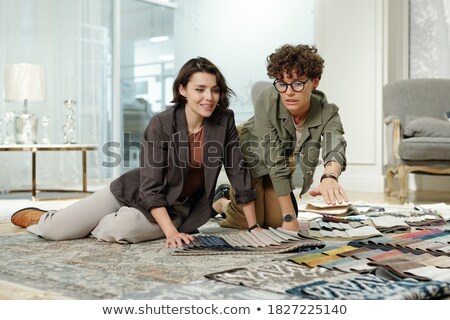 Stockfoto: Three Happy Business People Looking Through Documents Together In Office