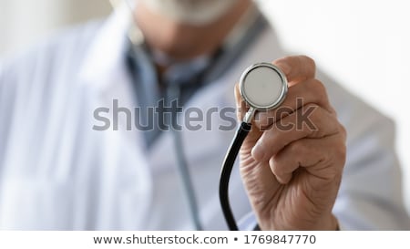 Stok fotoğraf: Doctors Hand Holding A Stethoscope Listening To Heartbeat