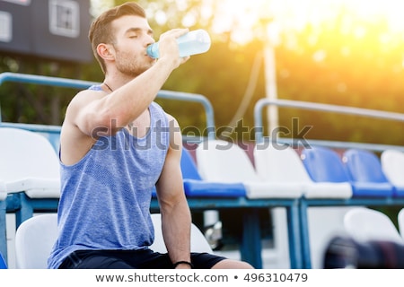 Stock foto: Tired Strong Sportsman Drinking Water