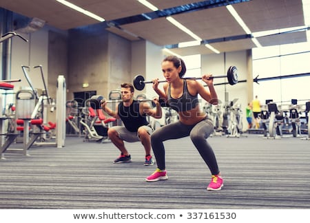 Foto stock: Women Exercising With Weights At Gym