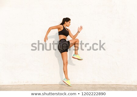 Foto d'archivio: Full Length Image Of Pretty Girl 20s In Tracksuit Doing Sports A