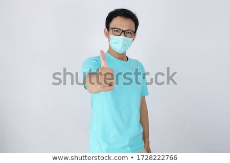 Stock foto: Young Asian Man Wear Medical Mask Is Give Ok Hand Sign With Confident Gestures Indonesian Man Weari