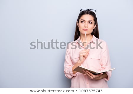 Foto d'archivio: Woman Portrait With Pencil And Notepad