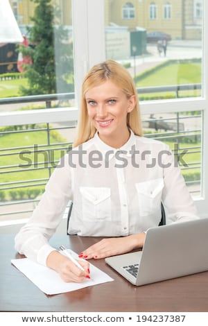 Stock foto: Sexy Businesswoman Sitting On Office Desk At Work