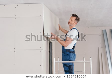 Foto stock: Man Doing Dry Walling Working