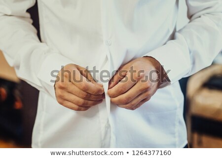 ストックフォト: Man Buttoning His Shirt