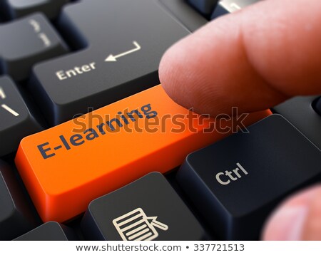 Foto stock: Finger Presses Orange Keyboard Button E Learning