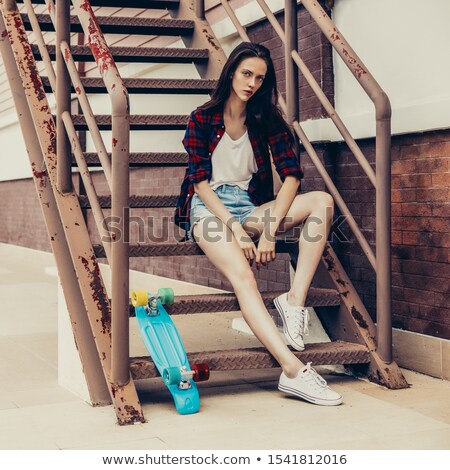 Stock photo: Beautiful Happy Woman In Checkered Shirt Jeans Shorts And Sneakers