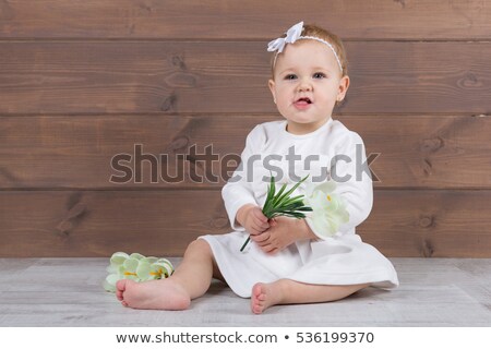 Stockfoto: Ballerina In White Dress Sitting Studio Background