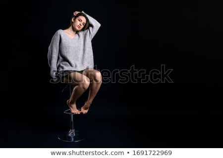 Foto stock: Beautiful Model Sitting On Chair In Studio