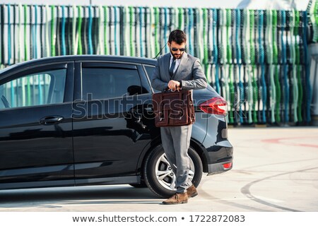 Zdjęcia stock: Young Attractive Businessman In Formal Wear Checking Time On His