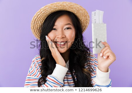 Stok fotoğraf: Happy Asian Woman Posing Isolated Over Purple Wall Background Holding Passport And Tickets