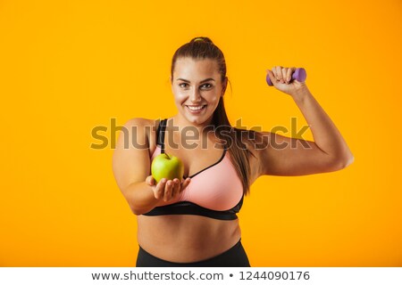 Stock foto: Portrait Of European Chubby Woman In Sportive Bra Holding Apple