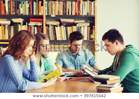 Stockfoto: Student Reading Books And Preparing For Exams In Library