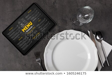 Foto d'archivio: Tableware With Online Menu On Tablet