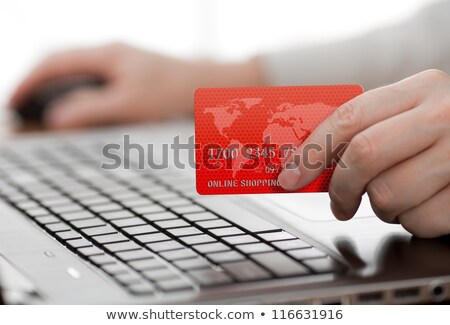 Stock fotó: Man Holding Credit Card In Hand And Entering Security Code Using