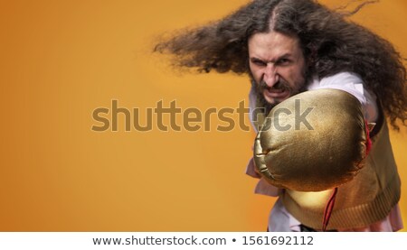 Zdjęcia stock: Portrait Of A Skinny Guy Throwing A Good Punch