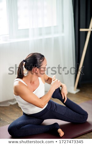 Stock fotó: Young Woman Practicing Yoga Doing One Legged King Pigeon Pose In Dark Room