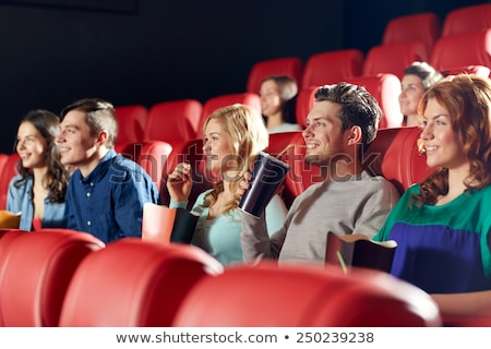 Foto d'archivio: Smiling Boy Eating Popcorn At Movie Theater
