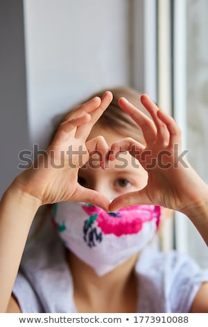 Stok fotoğraf: Little Girl Child In Mask Making Hearts From Hands Coronavirus Quarantine
