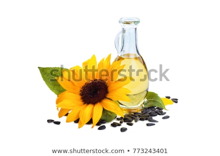 Foto stock: Bottle Of Oil And Sunflower With Leaves