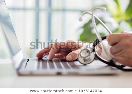 Stock fotó: Nurse Looking At Notes