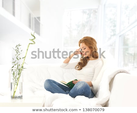 Stok fotoğraf: Young Woman Reading Pulp Fiction Book