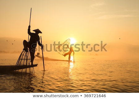 Stock photo: Burmese Fisherman Catching Fish In Traditional Way Inle Lake Myanmar