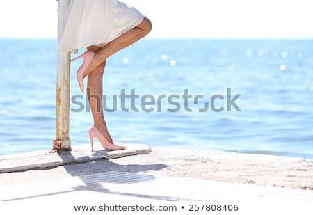 Stock photo: Legs Of A Woman Wearing Stilettos