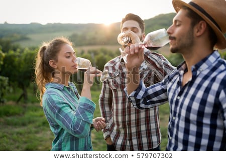Сток-фото: Couple Tasting Wine In A Vineyard