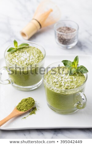 ストックフォト: Matcha Green Tea Chia Seed Pudding Dessert With Fresh Mint And Coconut On A White Stone Background