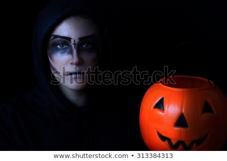 Girl In Scary Makeup With Pumpkin Container On Black Background ストックフォト © tab62