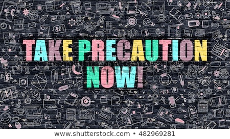 Stock photo: Multicolor Take Precaution Now On Dark Brickwall Doodle Style