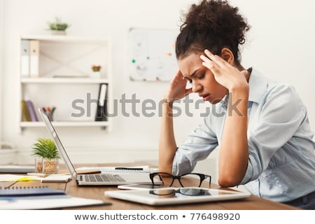 Foto stock: Tired Young Woman With Headache In An Office