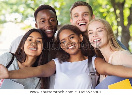 Stok fotoğraf: Group Of Happy Teenage Students Walking Outdoors