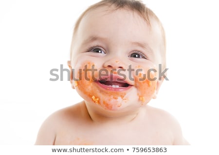 Stockfoto: Little Baby Eating Her Dinner Spaghetti And Making A Mess On His Face